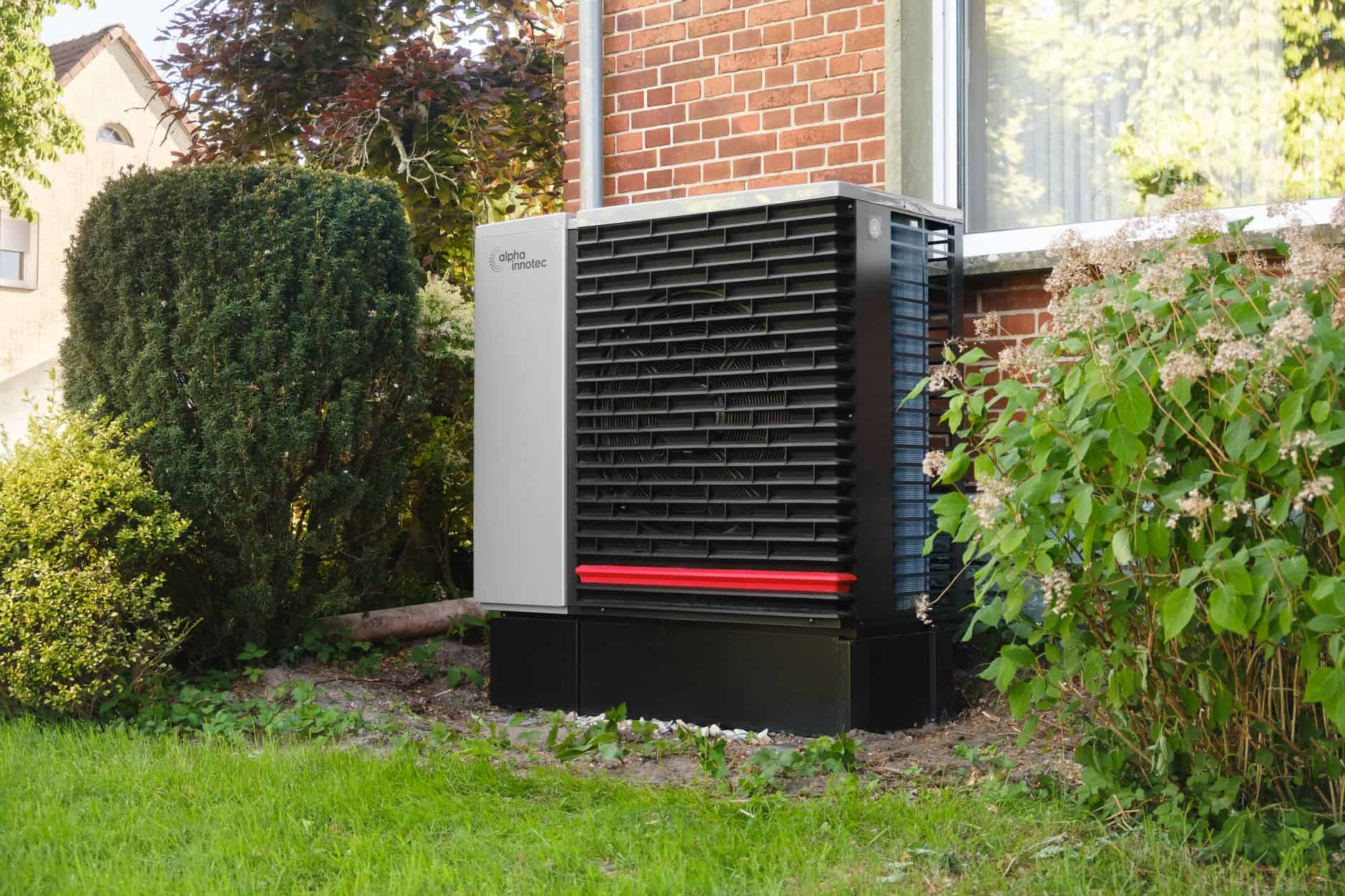 Air source heat pump outside a house in a garden