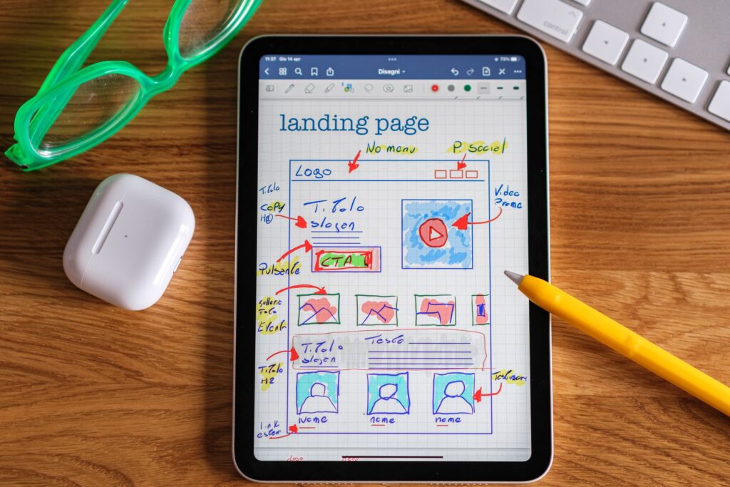 Tablet showing a hand-drawn landing page layout for a Google Ads campaign