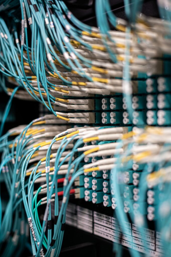 Rows of network cables plugged into a server patch panel, the infrastructure behind technical SEO