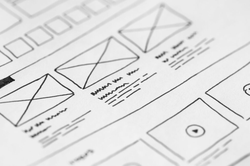 Hand-drawn wireframe of a website layout on paper, the planning stage of a website redesign